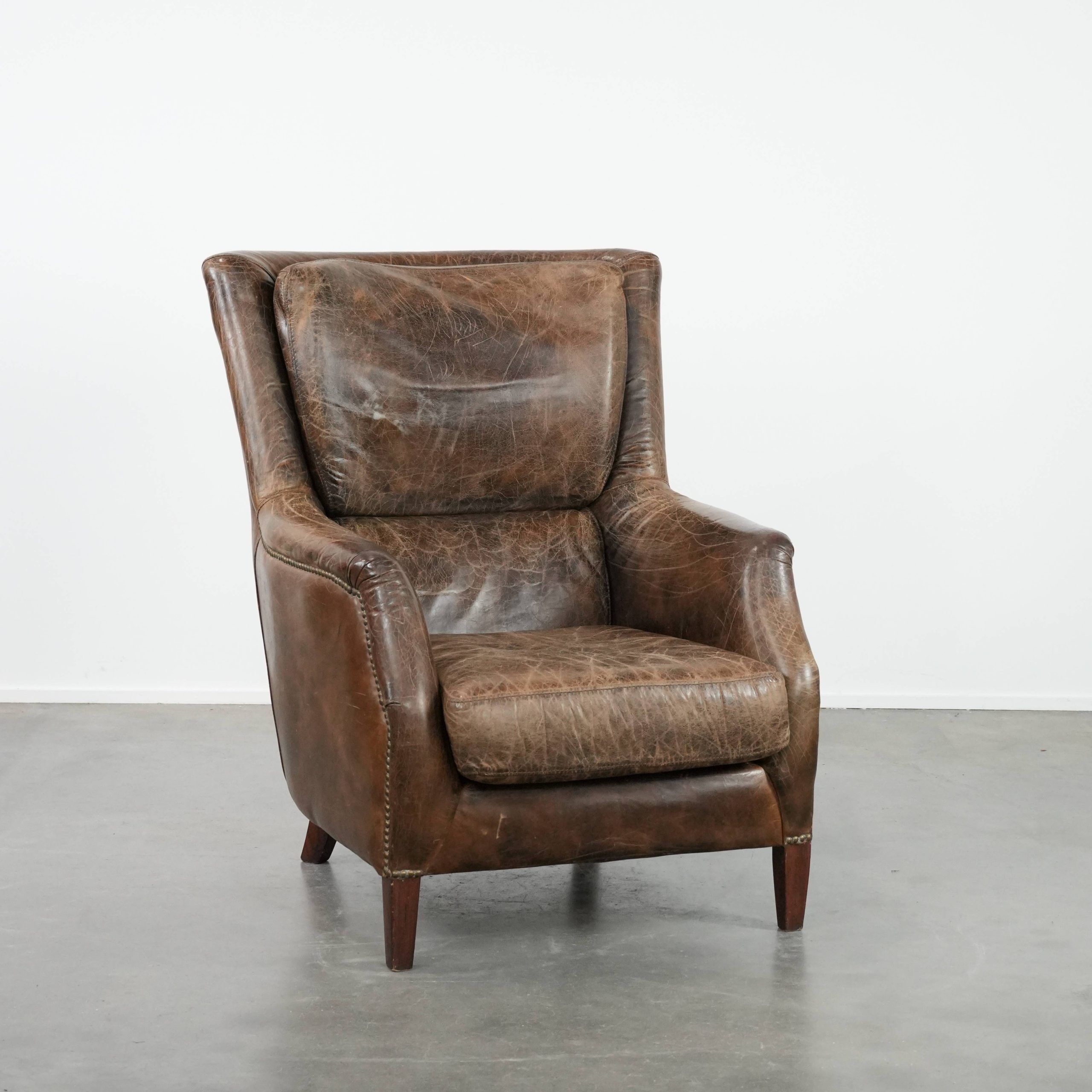 Very comfortable vintage cow leather armchair with character
