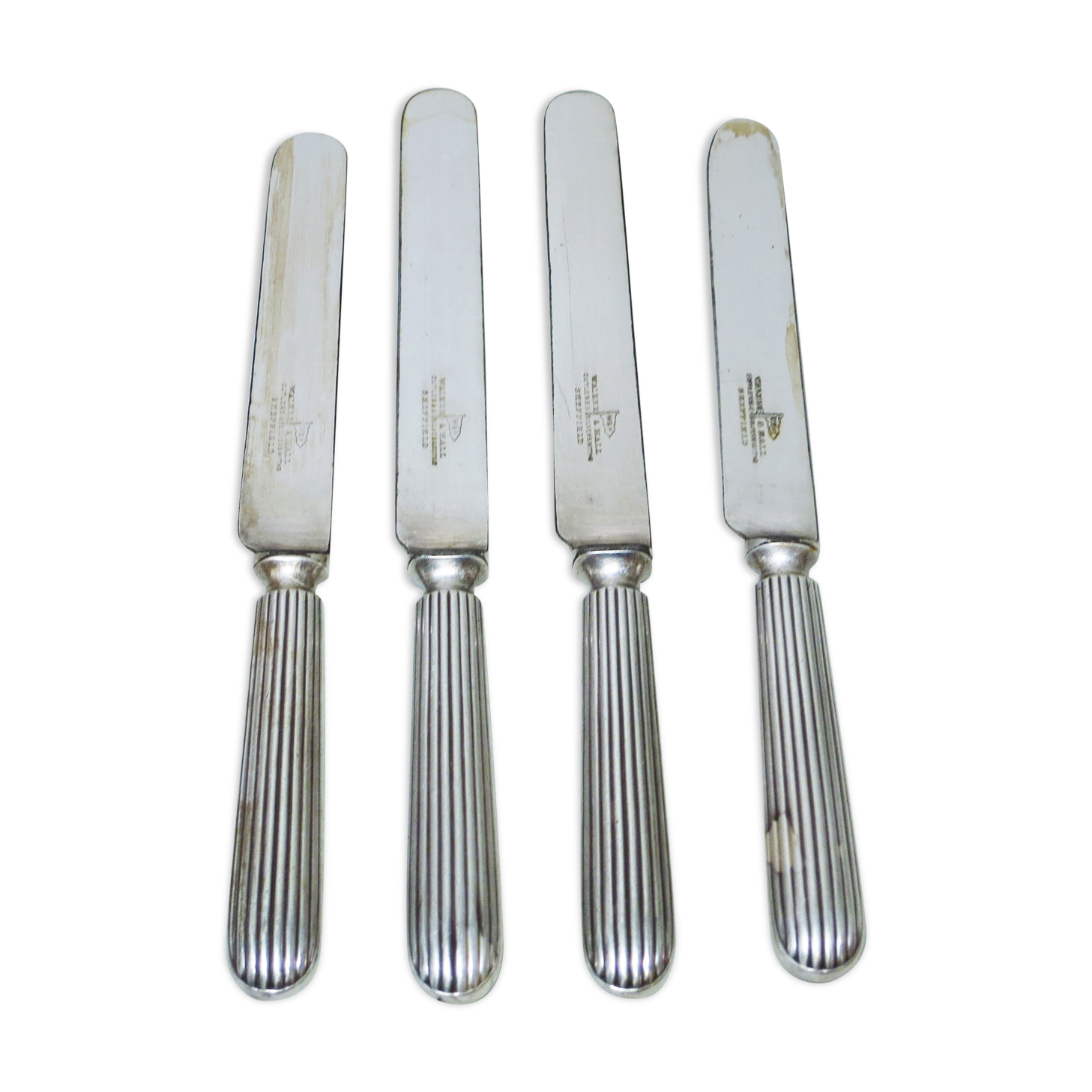 Set of four silver metal knives