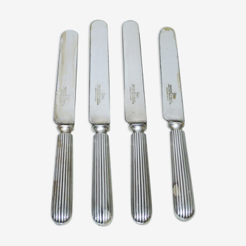 Set of four silver metal knives