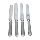Set of four silver metal knives