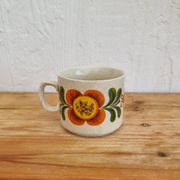 A pair of vintage Weidmann cups with an orange flower motif from the 1970s.