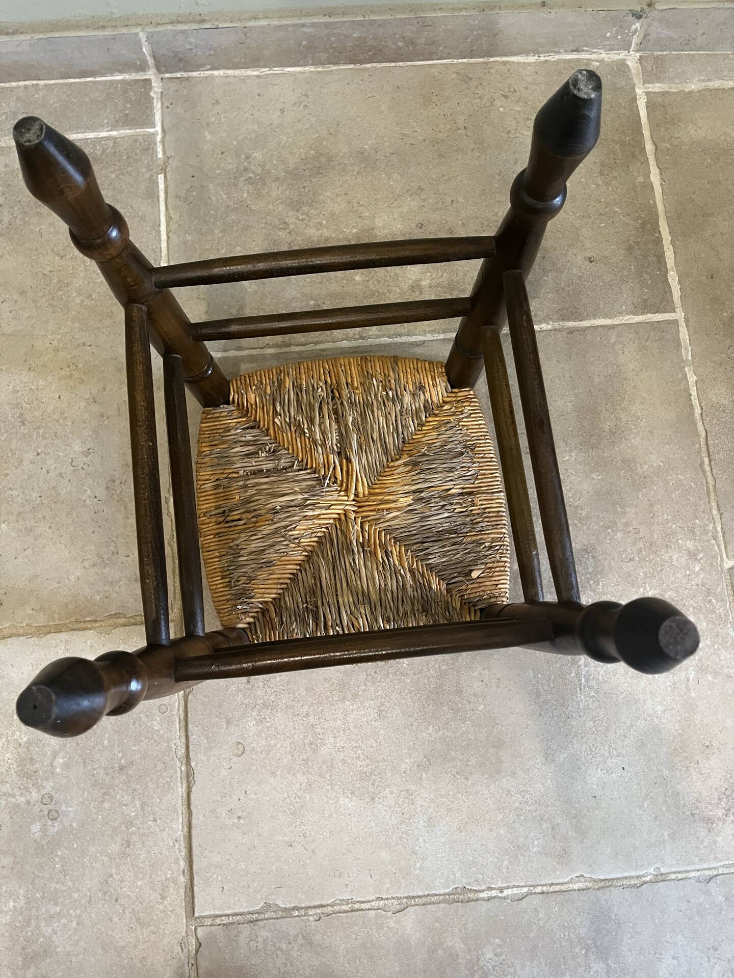 Wooden stool with a straw seat