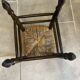 Wooden stool with a straw seat