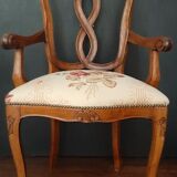 Upholsterer armchair covered with a publisher fabric with a central floral pattern