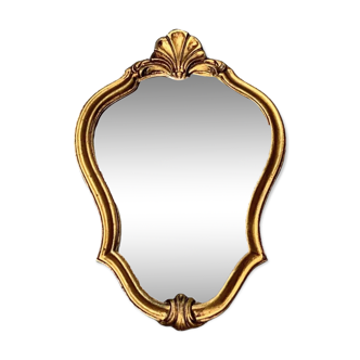 Old small wall mirror in golden resin