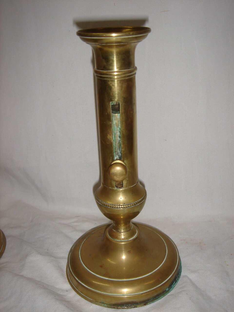 Pair of brass push-up candlesticks, 1940