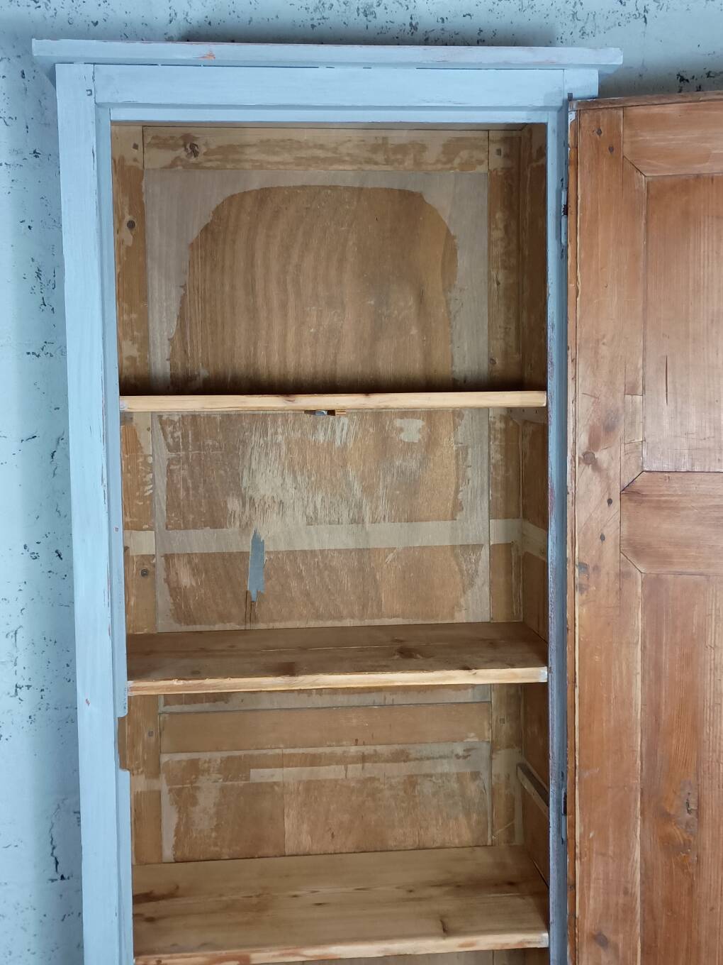 Rustic antique bonnetière in weathered blue-grey wood.