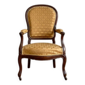 Classic cabriolet armchair in wood and textured gold fabric.
