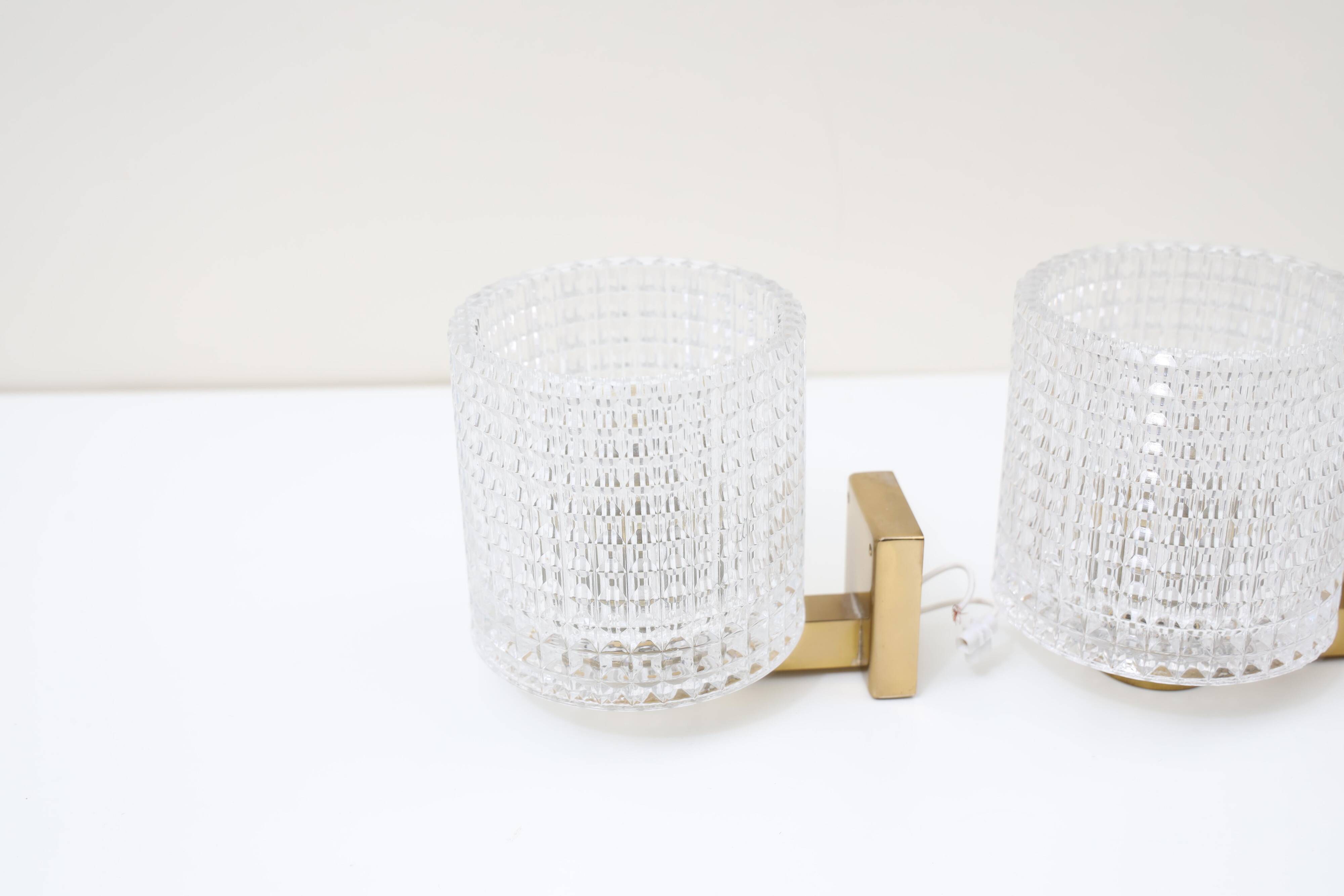 Carl Fagerlund for Orrefors Pair of wall lights in brass and glass Sweden 1960