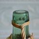 Viresa glass bottle and woven rattan