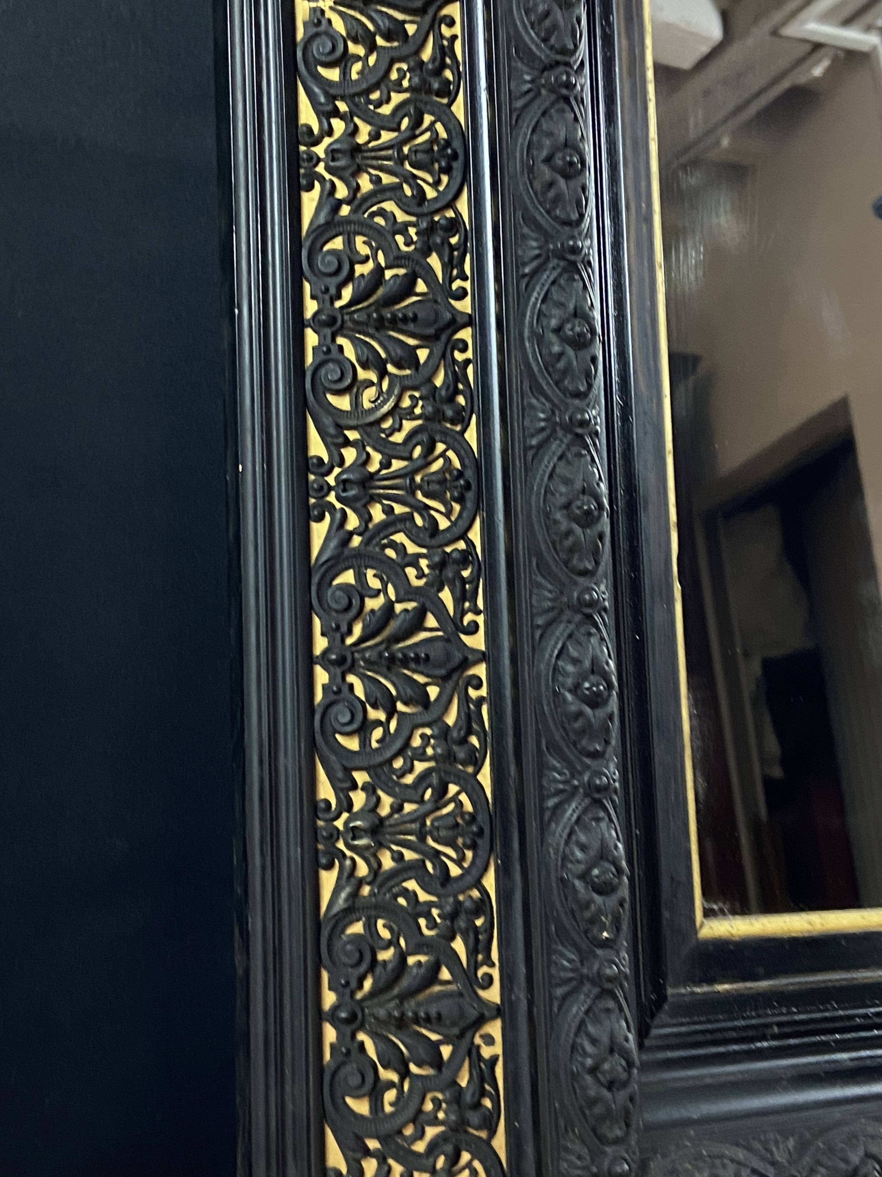 19th-century mirror Napoleon III in blackened wood on a gold background.