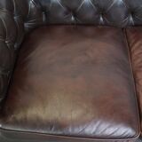 Old dark brown 3-seater cowhide chesterfield sofa with lots of character