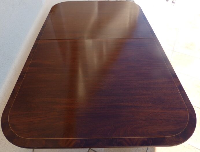 Mahogany top table inlaid with light wood nets and brass toes