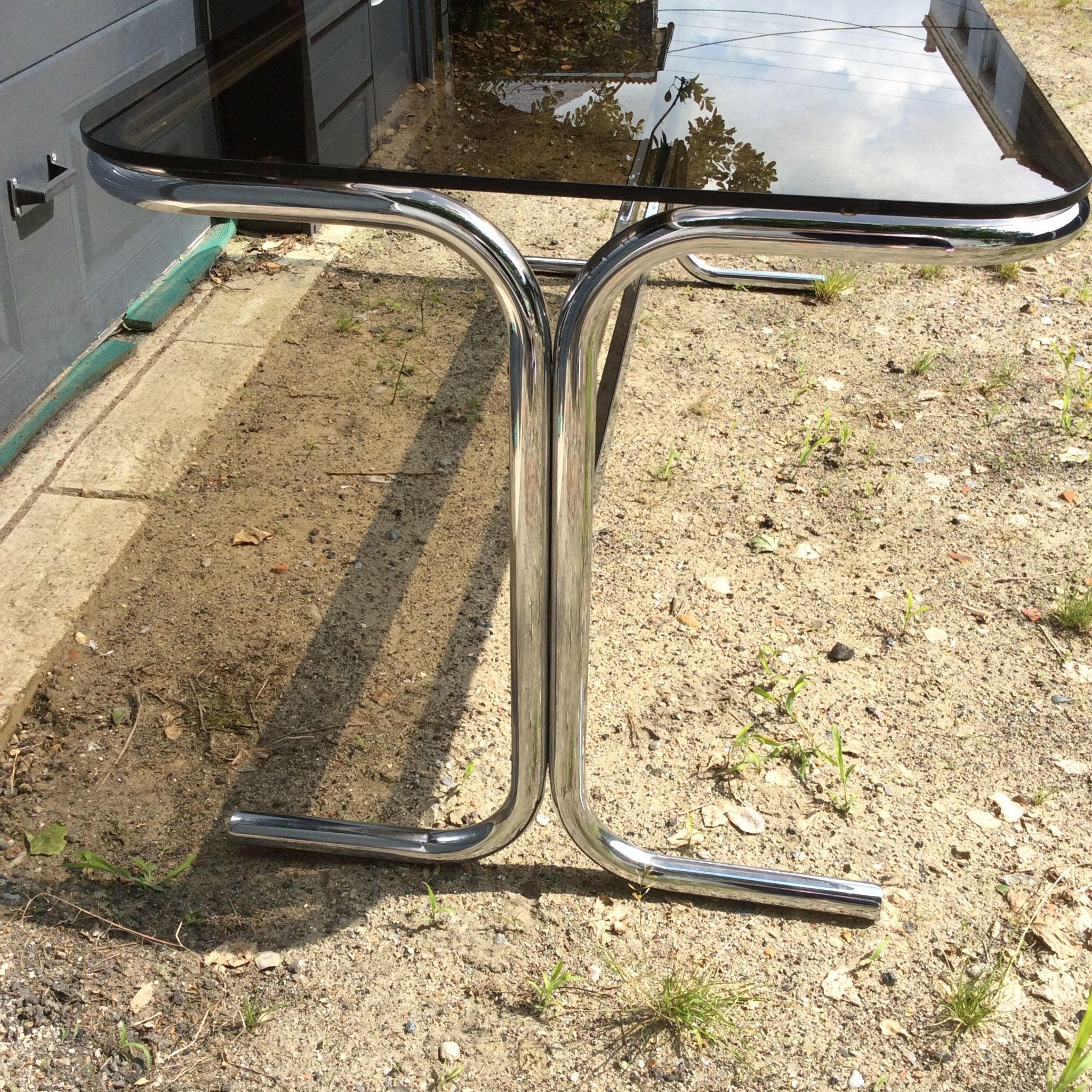 Dining table of the 70s in smoked glass and chromed metal