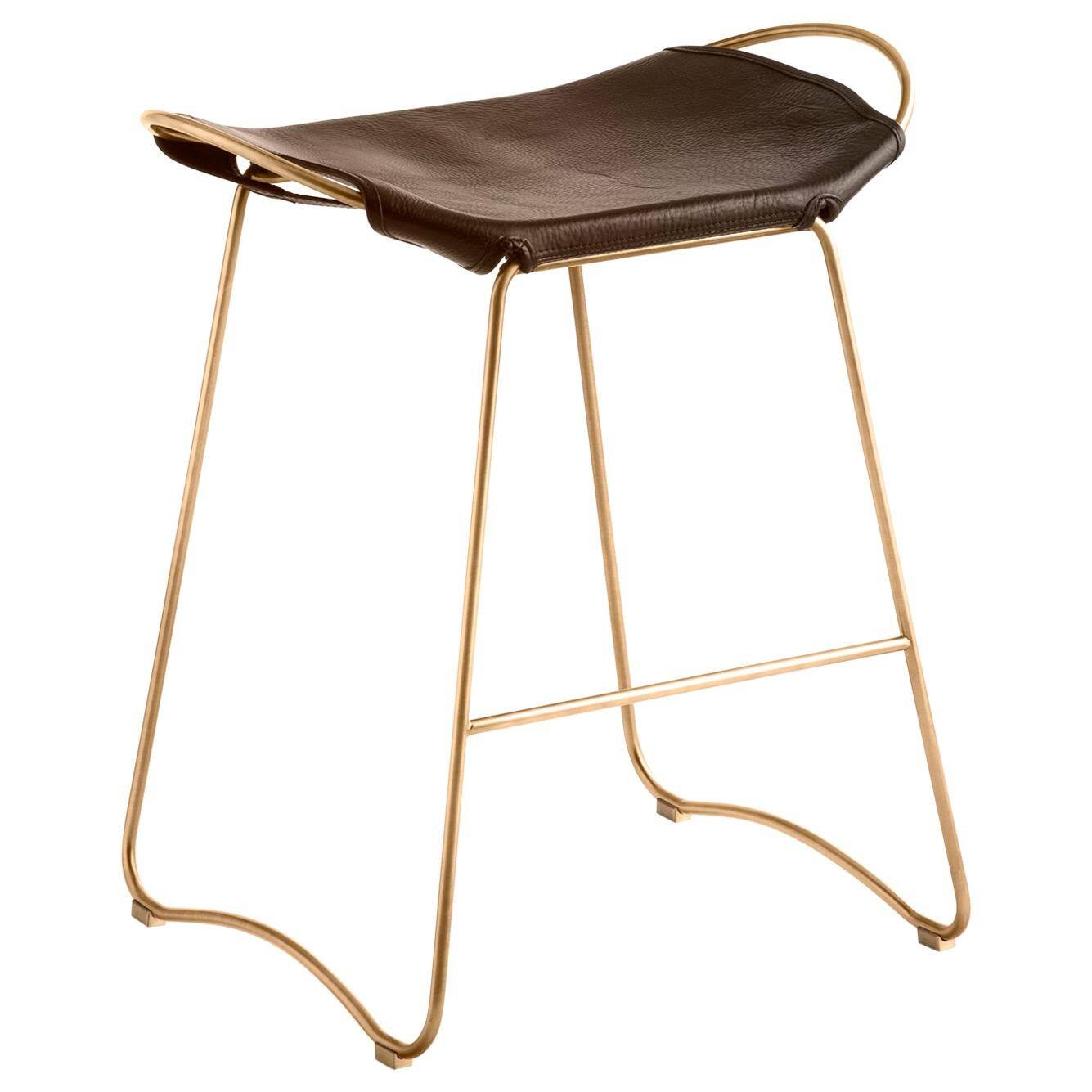 Contemporary kitchen stool in aged brass and dark brown leather.