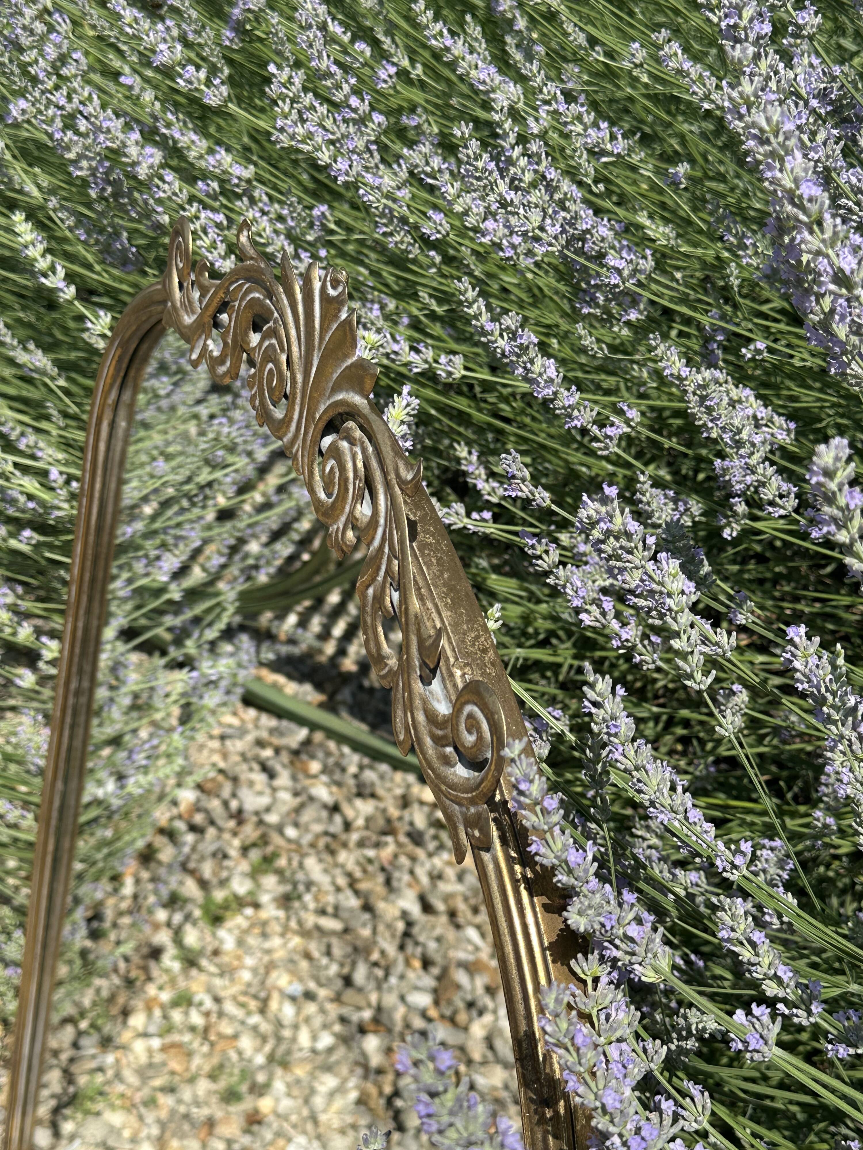 Golden metal pediment mirror from the 2000s.