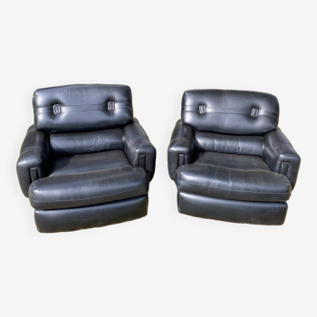 Pair of black imitation leather armchairs