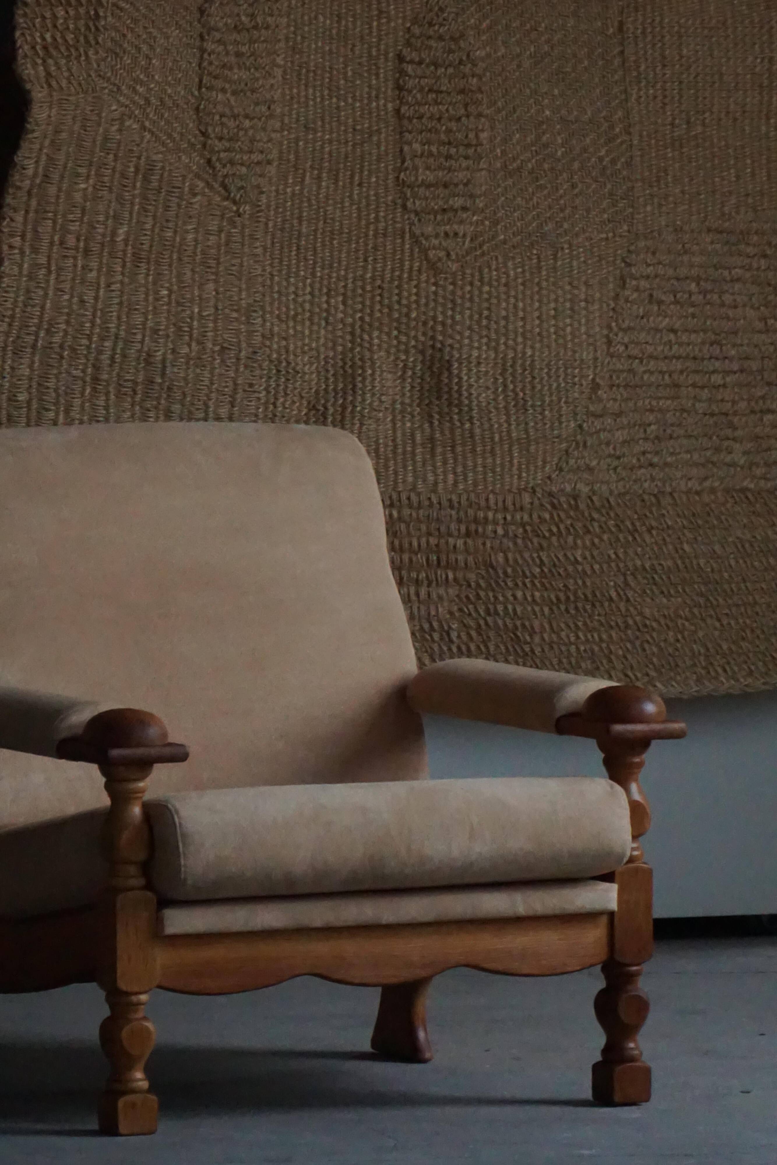 Pair of armchairs by Henning Kjærnulf, Oak Oak and Alcantara, mid-20th century, 1960s.