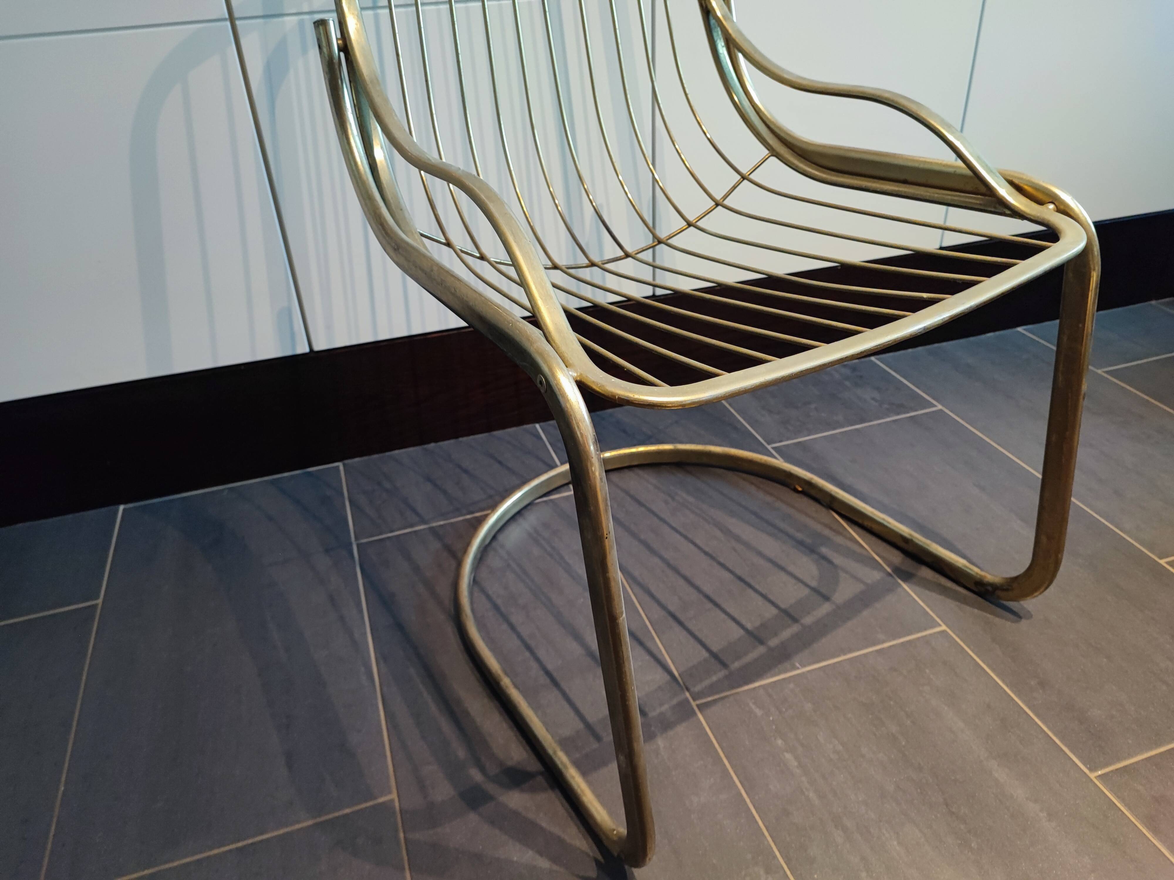 Tubular metal chair covered with gilding