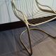 Tubular metal chair covered with gilding