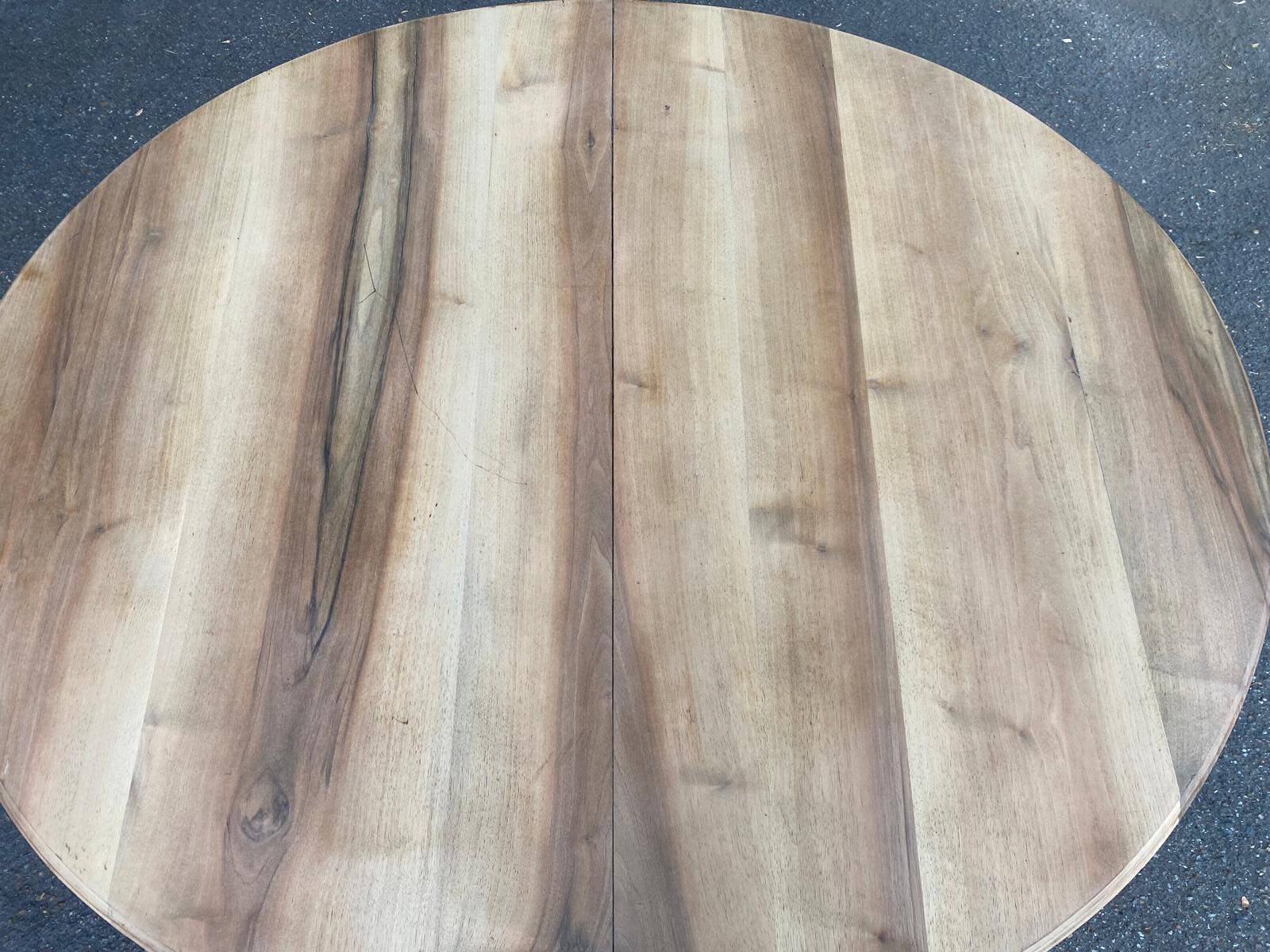 Art Deco round extendable dining table stripped in solid walnut from the 1920s.