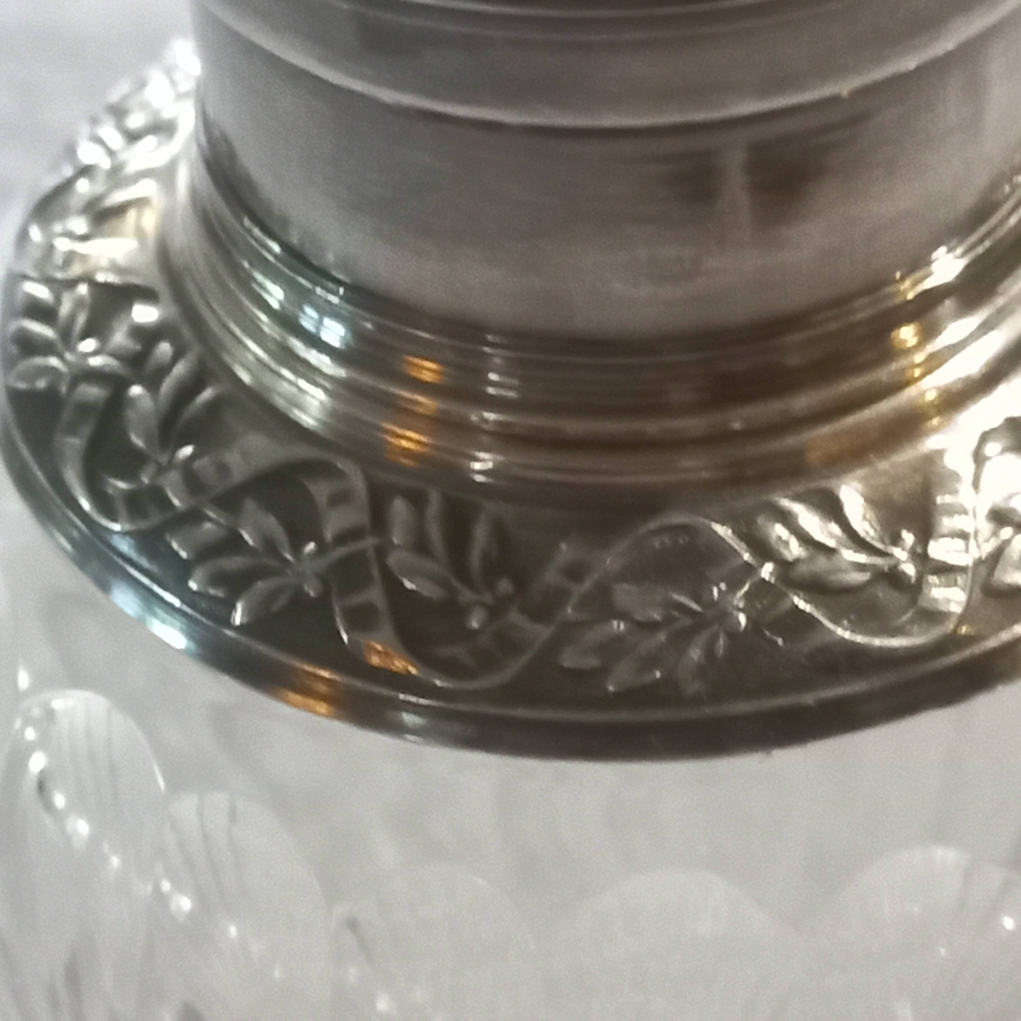Crystal and solid silver shaker, neck brace and master's mark.