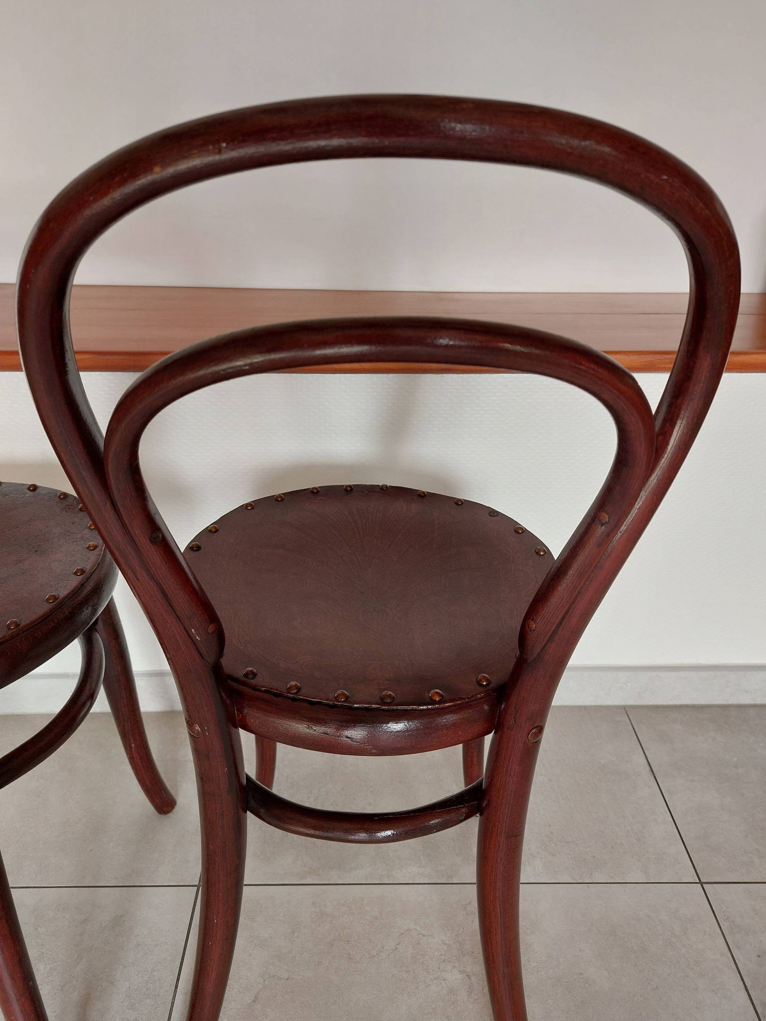 pair of round bistro chairs with a pattern on the seat, vintage