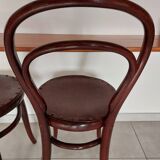 pair of round bistro chairs with a pattern on the seat, vintage