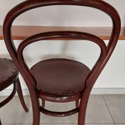 pair of round bistro chairs with a pattern on the seat, vintage