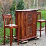 Exotic wood bar with 2 high stools.
