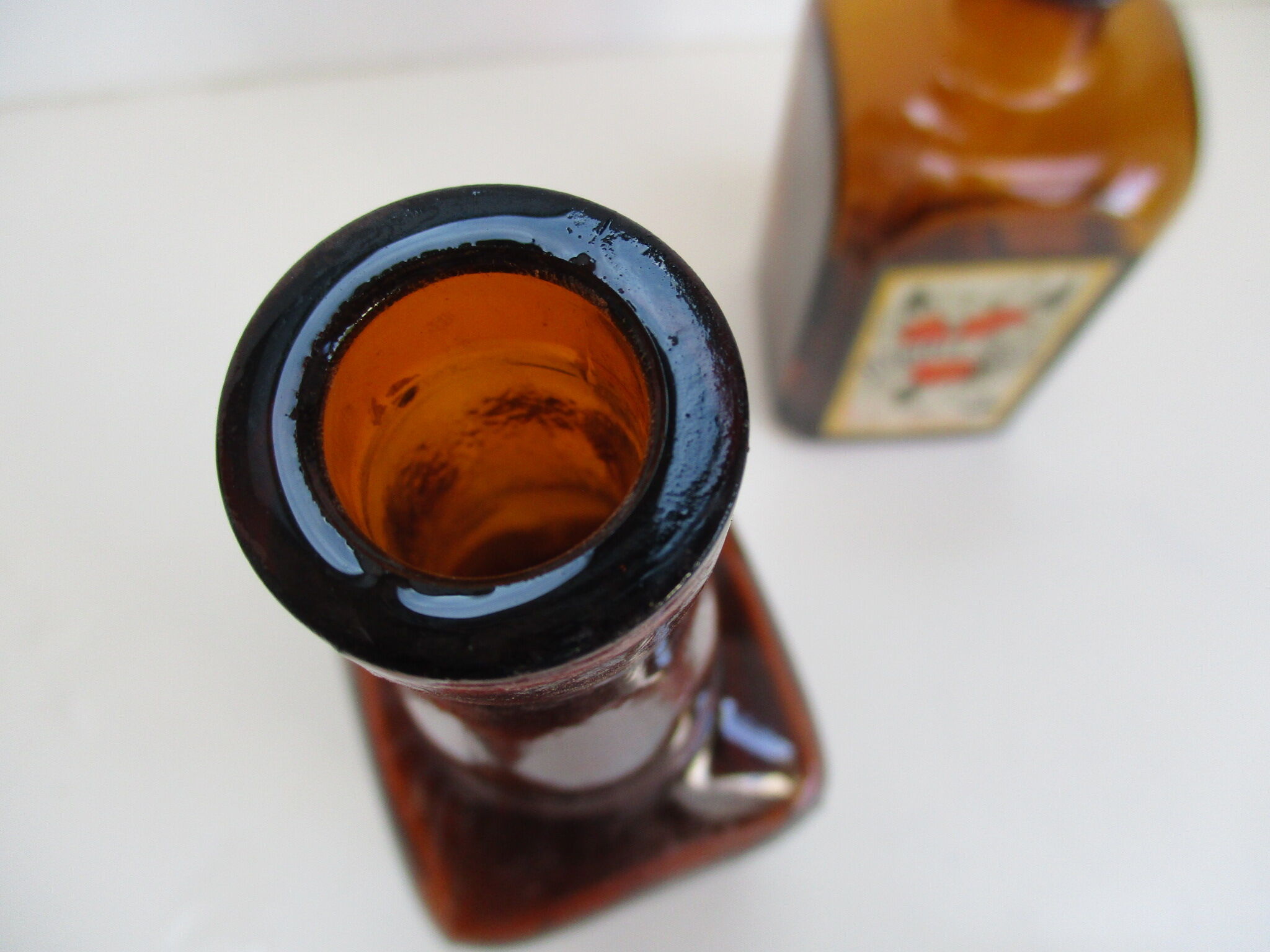 2 amber glass bottles with their old labels