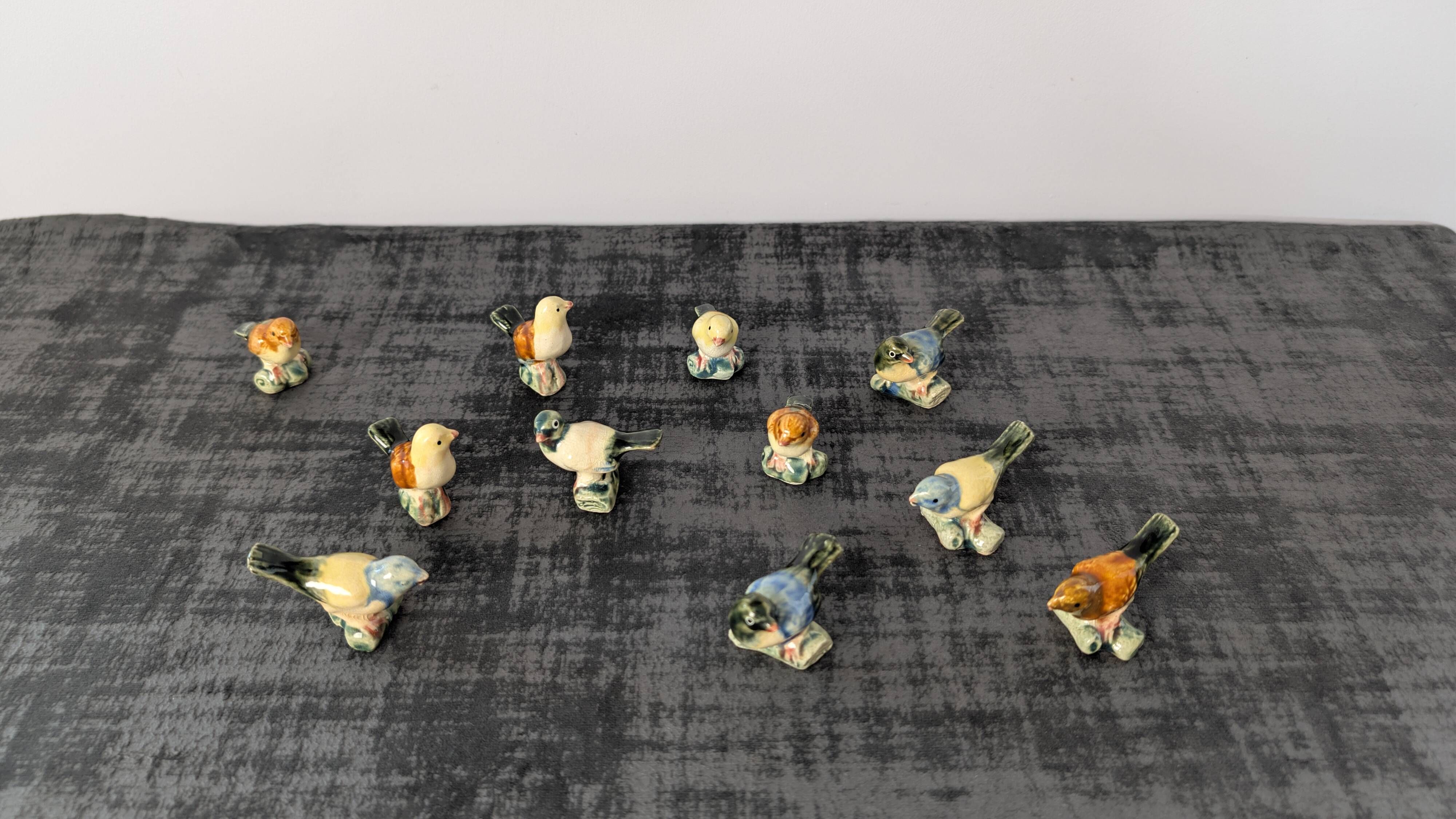 Set of 11 miniature birds in polychrome glazed ceramic.