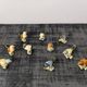 Set of 11 miniature birds in polychrome glazed ceramic.