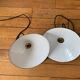 Old pair of white industrial metal suspensions with black border