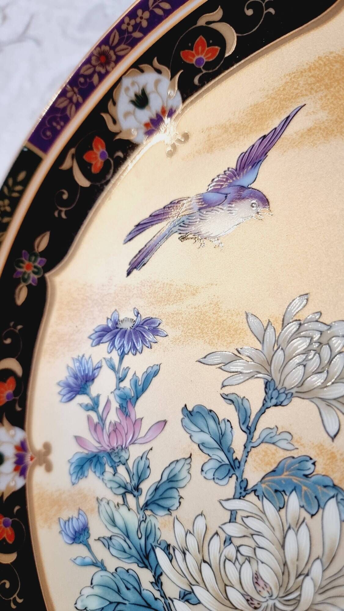 Vintage Japanese decorative plate with chrysanthemum and bird patterns.