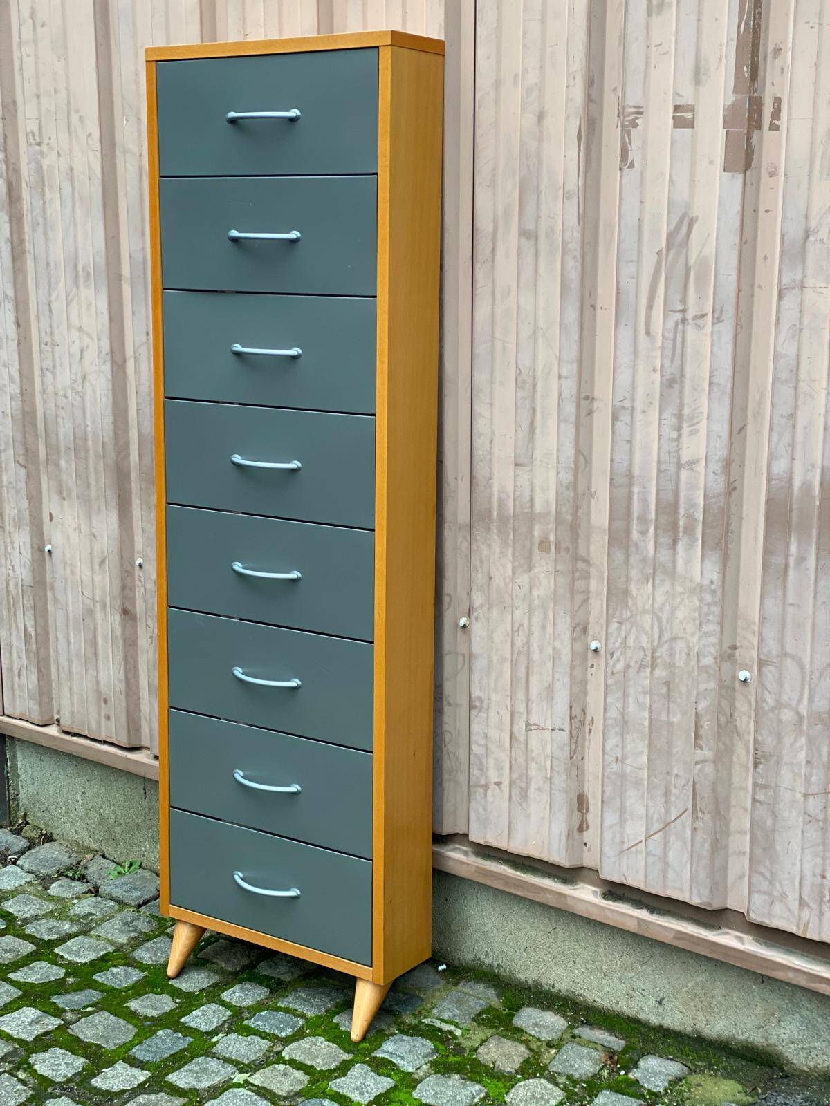 Scandinavian shoe storage cabinet in grey wood and metal.