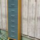 Scandinavian shoe storage cabinet in grey wood and metal.