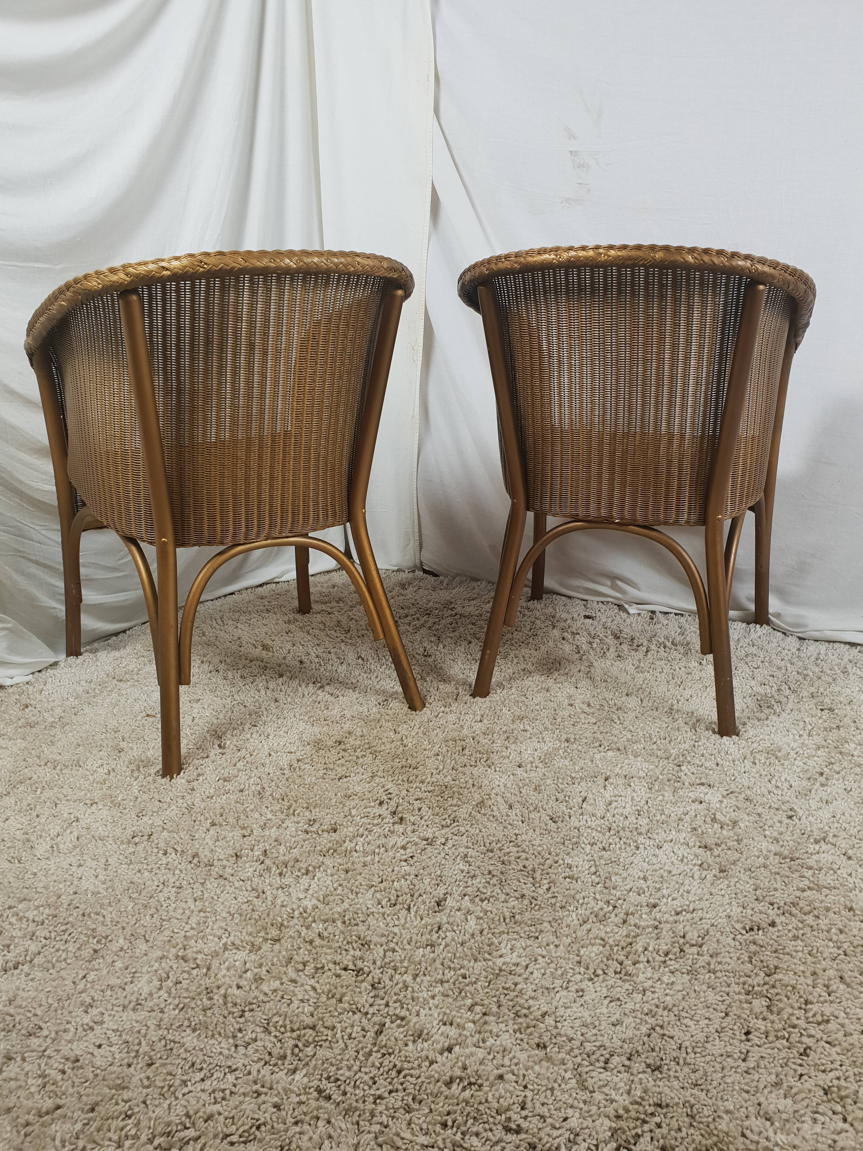 Paire de fauteuil Lloyd Loom doré