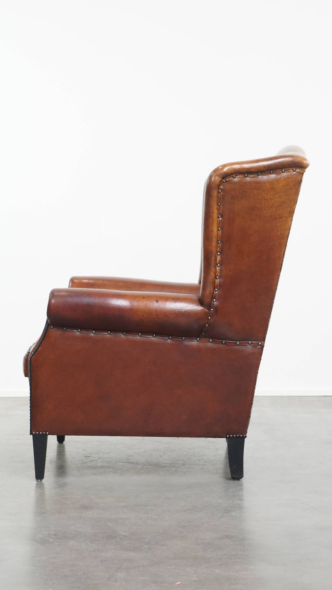 Sheepskin Wingback Chair with Warm Tones and Black Piping