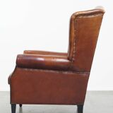 Sheepskin Wingback Chair with Warm Tones and Black Piping