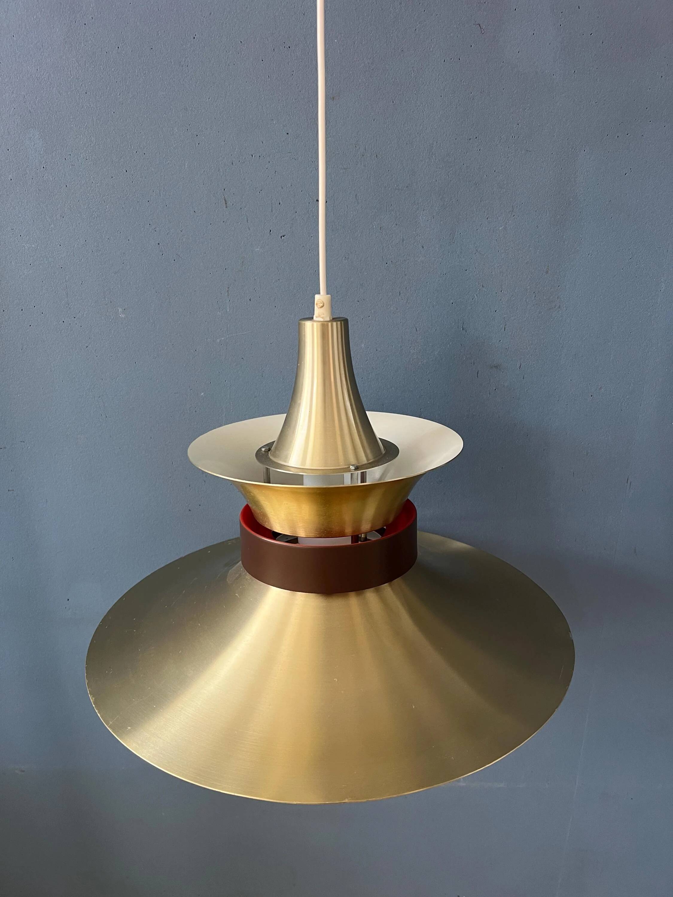 Large UFO flying saucer pendant light with orange light.