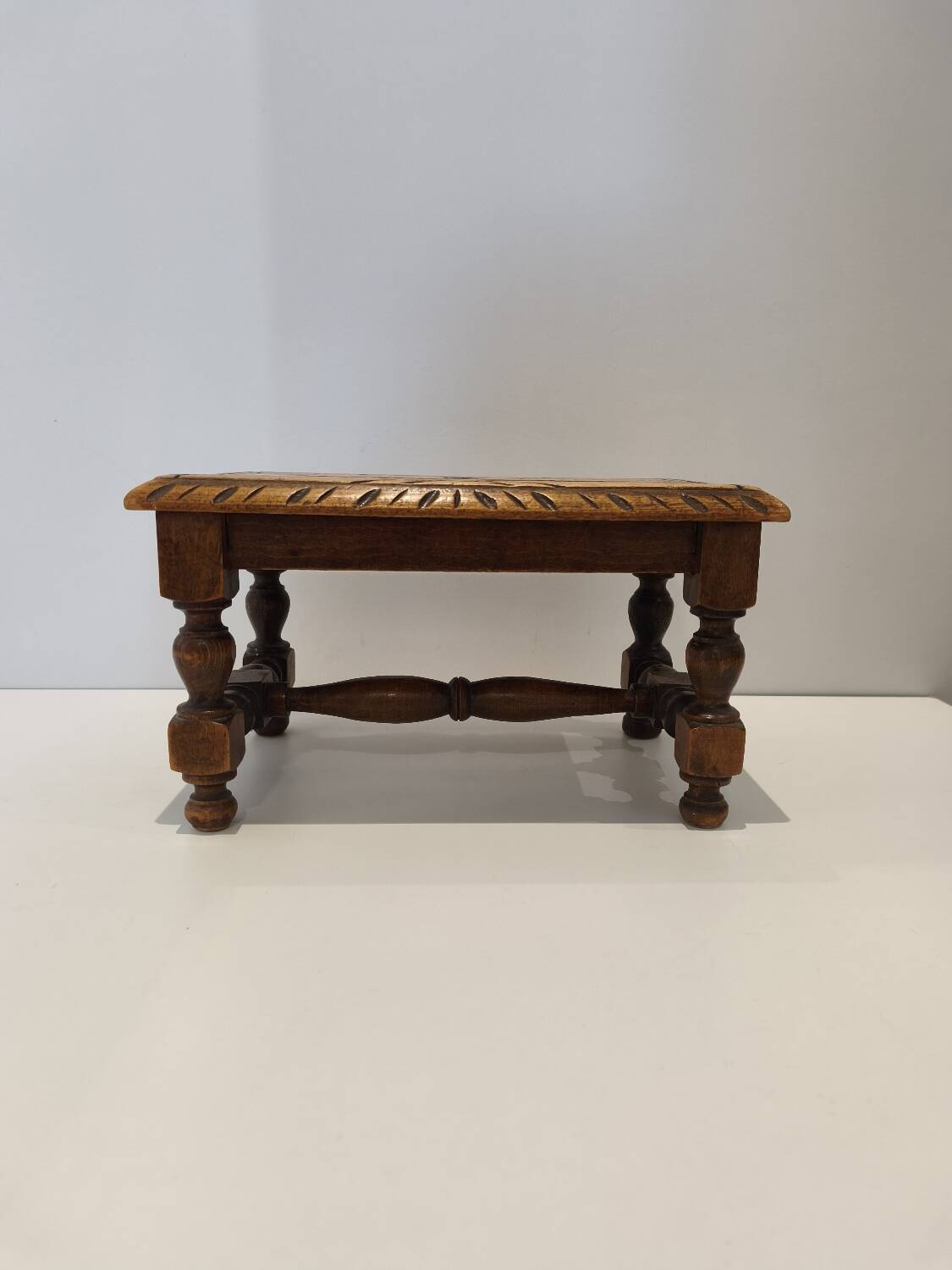 Small vintage carved solid wood footrest bench