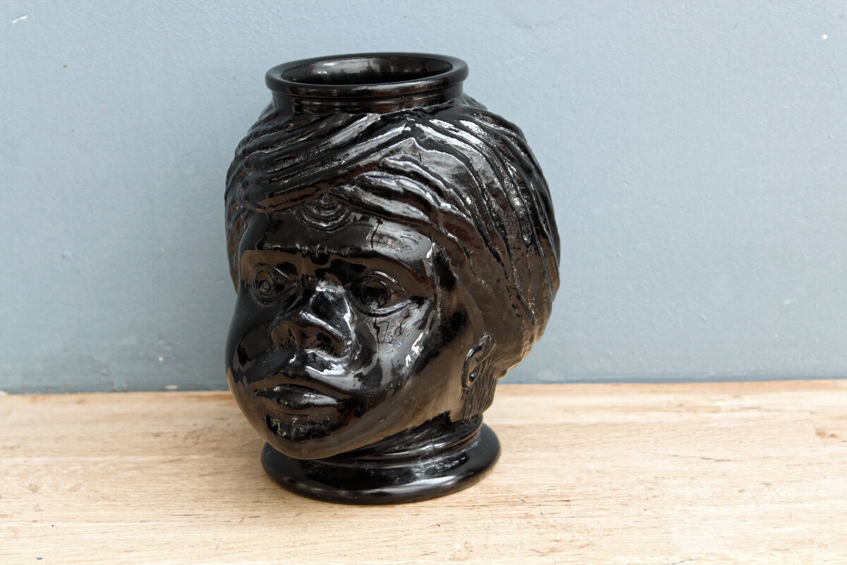 Molded glass vase, nubian's head