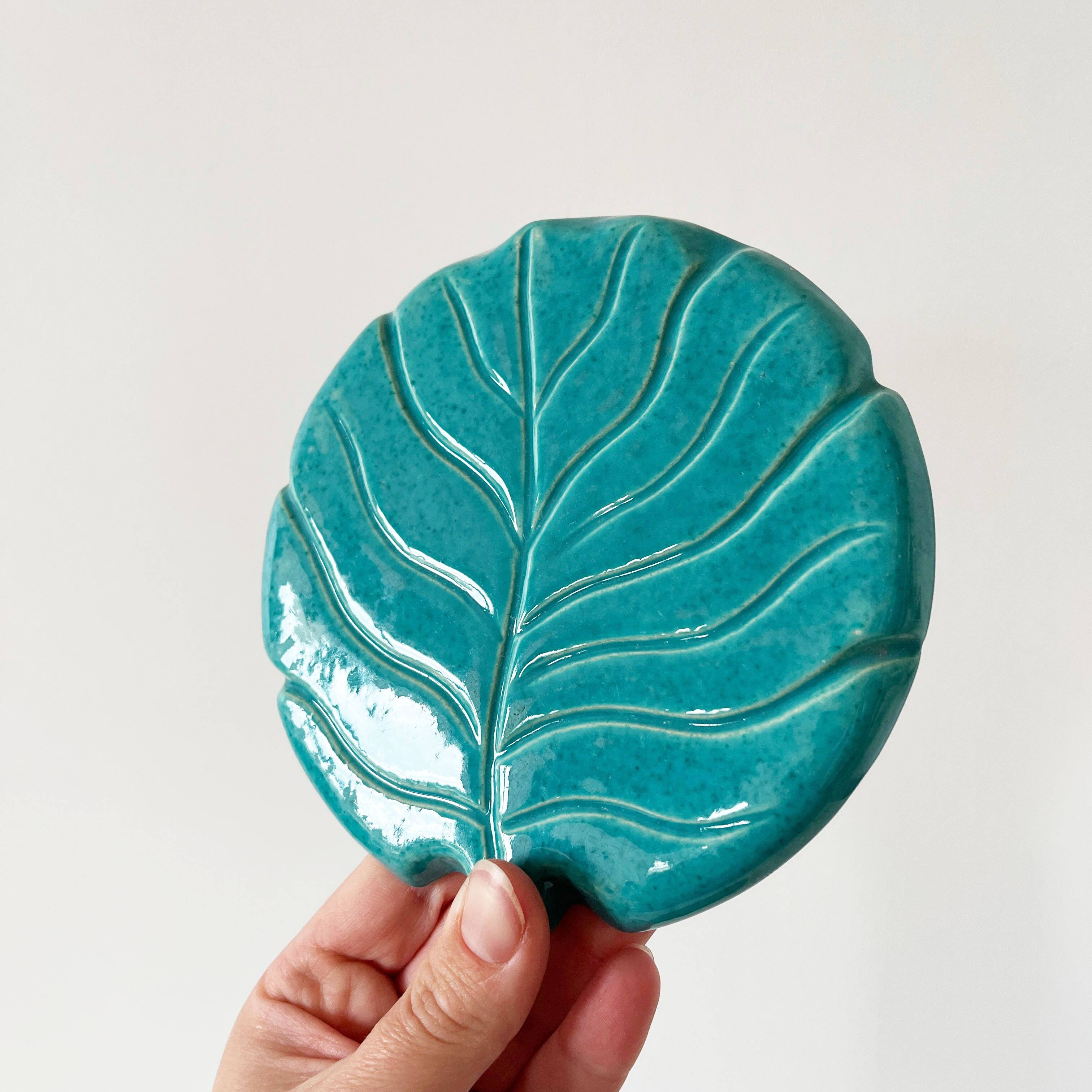 Ceramic trivet and bottle coaster from the 1950s.
