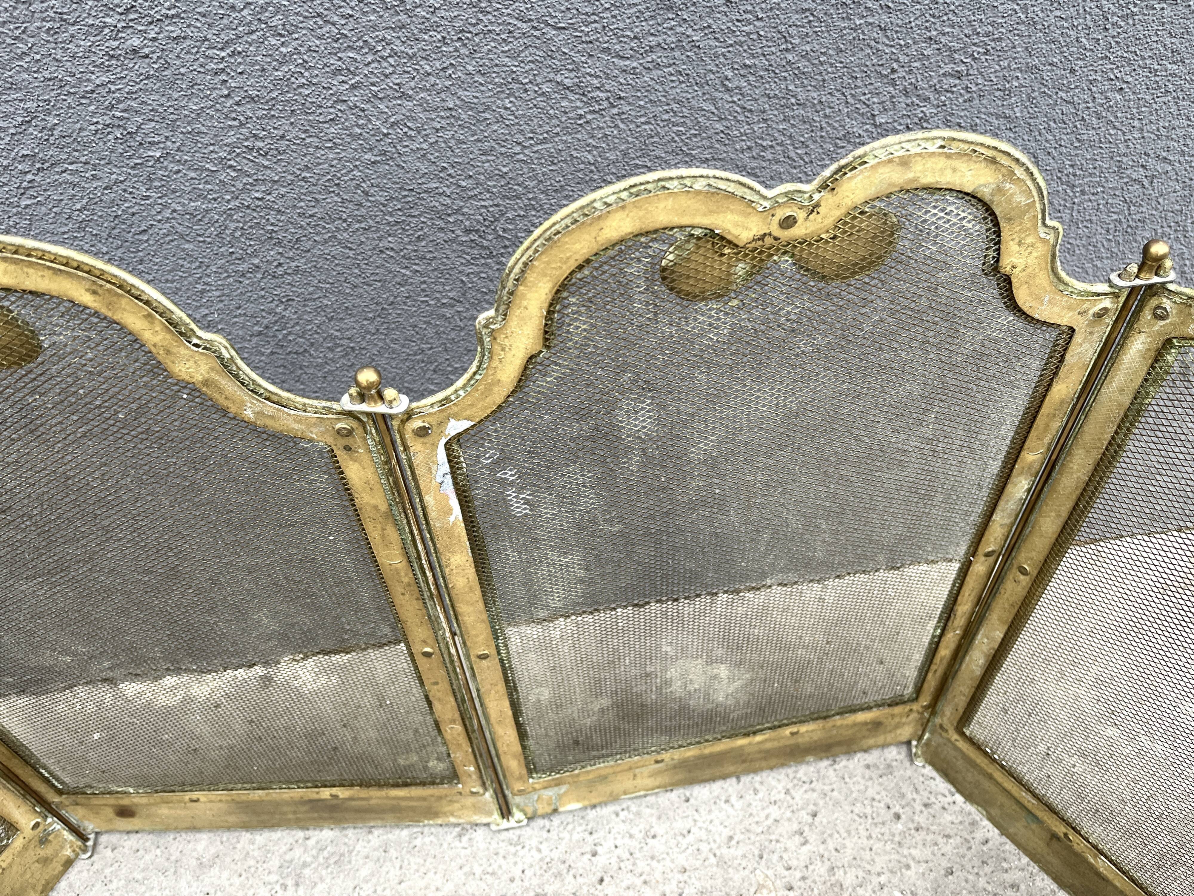 Antique brass fireplace screen from 1920, vintage spark guard.