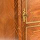 In-between furniture in marquetry decorated with a trophy decoration of musical instruments