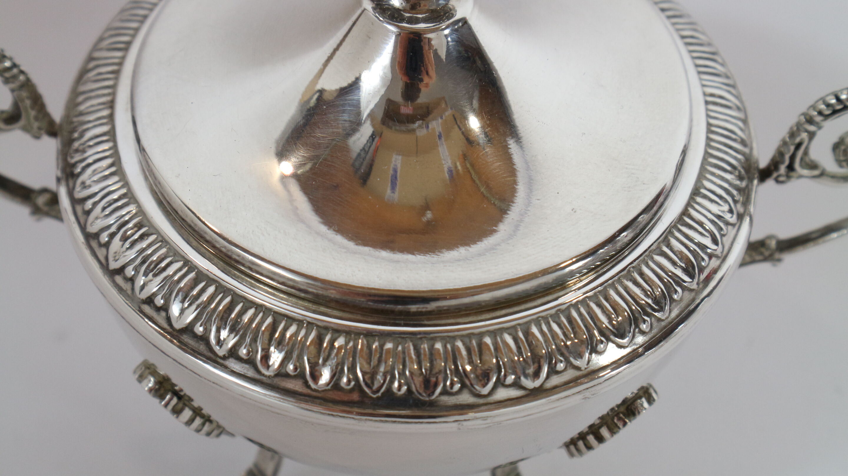 Silver sugar bowl with paw feet and ornate handles