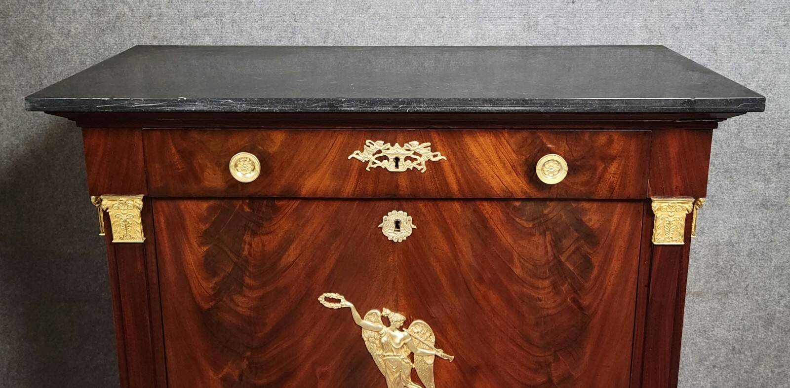 Rare four-column secretary from the Empire period in flame mahogany and bronze.