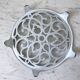 Vintage white cast iron trivet from the early 20th century