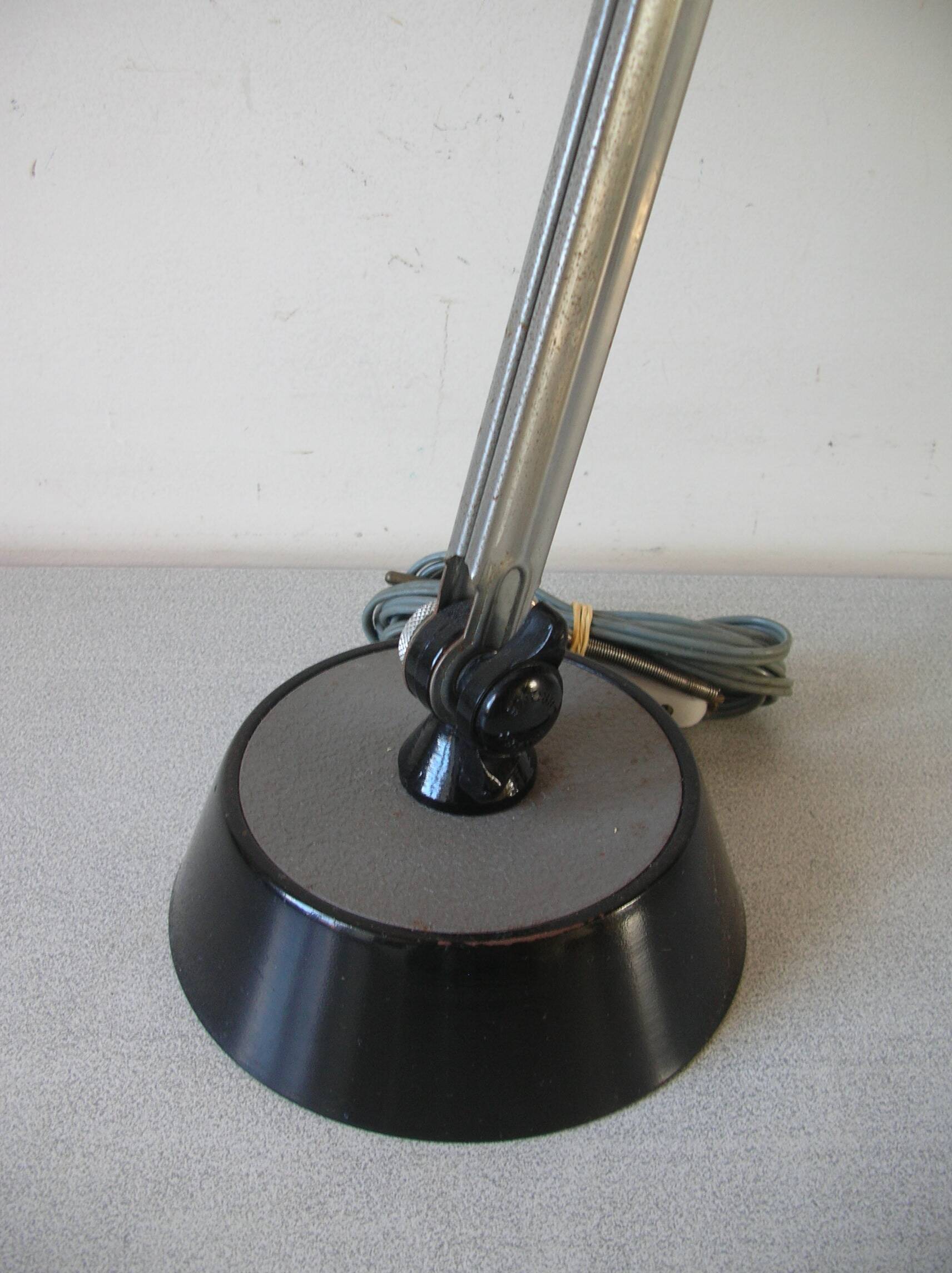 Super Chrome old articulated metal desk lamp on workshop decor base